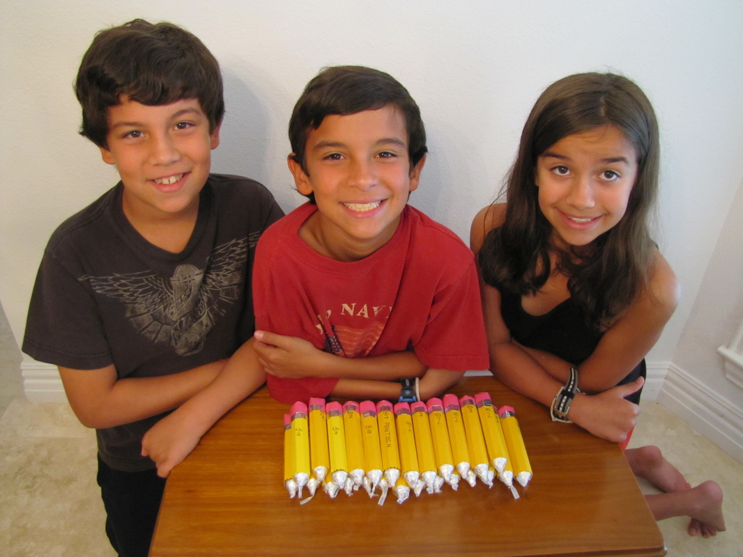 Triplets with pencils made from rolo candy